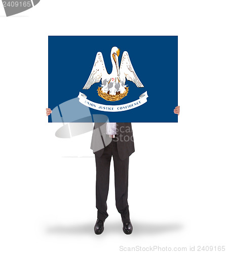 Image of Smiling businessman holding a big card, flag of Louisiana
