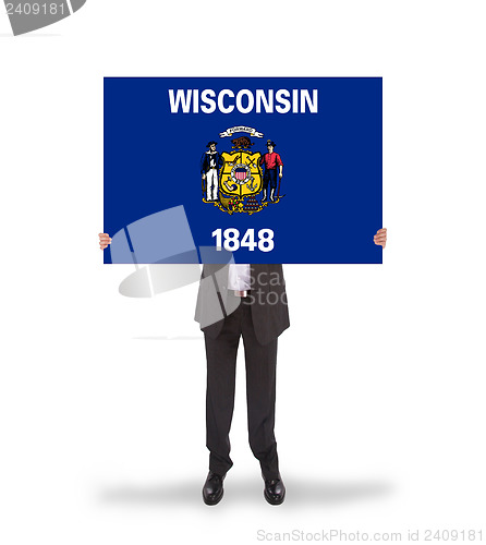 Image of Smiling businessman holding a big card, flag of Wisconsin