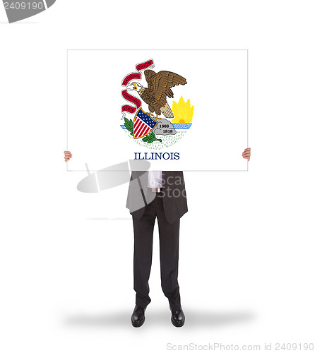 Image of Smiling businessman holding a big card, flag of Illinois