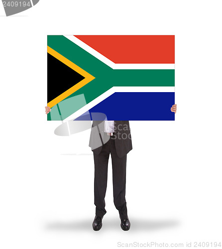 Image of Smiling businessman holding a big card, flag of South Africa