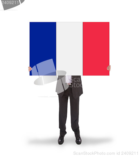 Image of Smiling businessman holding a big card, flag of France