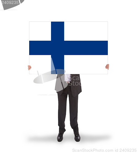 Image of Smiling businessman holding a big card, flag of Finland