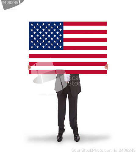 Image of Smiling businessman holding a big card, flag of the United State