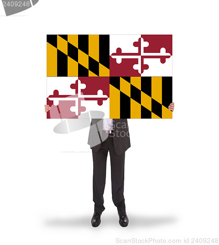 Image of Smiling businessman holding a big card, flag of Maryland