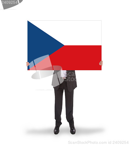 Image of Smiling businessman holding a big card, flag of the Czech Republ