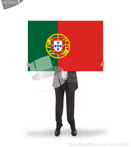 Image of Smiling businessman holding a big card, flag of Portugal