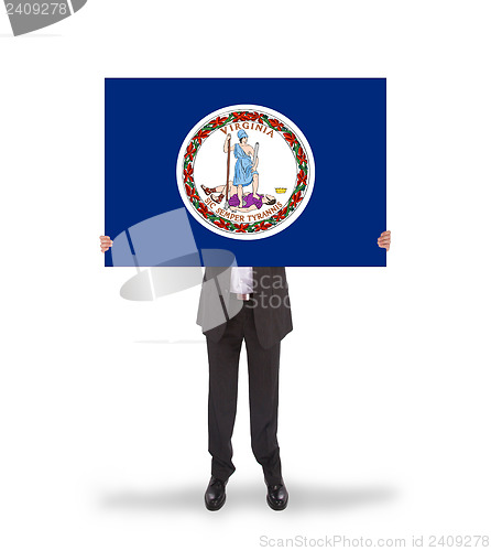 Image of Smiling businessman holding a big card, flag of Virginia