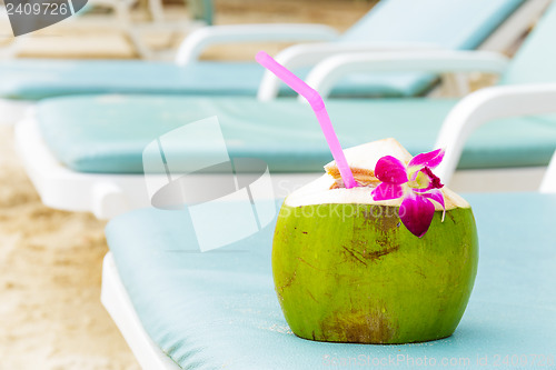 Image of Sunbathing with coconut drink