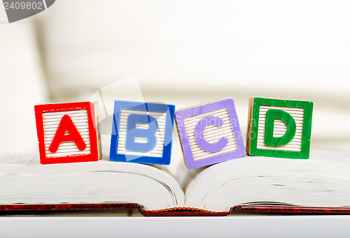 Image of Alphabet block with ABCD on book 