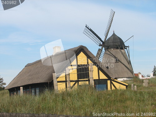 Image of Windmill and house with straw roof