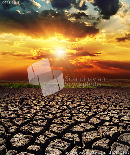 Image of dramatic sunset over drought land