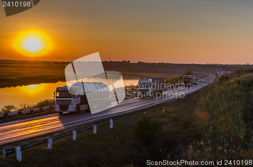 Image of sunset over road with autos