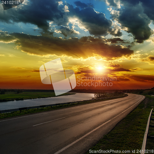 Image of dramatic sunset over asphald road