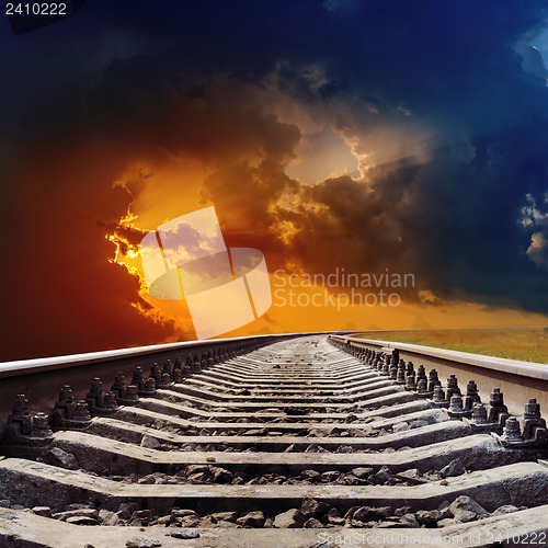 Image of railroad goes to dramatic sunset
