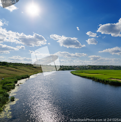 Image of sun over river with light waves