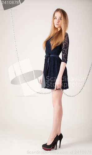 Image of beautiful fashionable woman near chain swing
