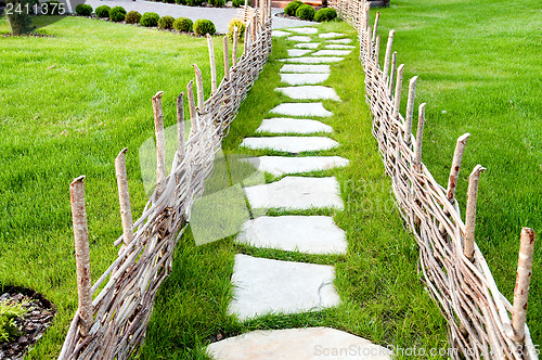 Image of old-fashioned alley with green grass