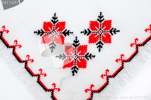 Image of part of embroidered serviette by cross-stitch pattern