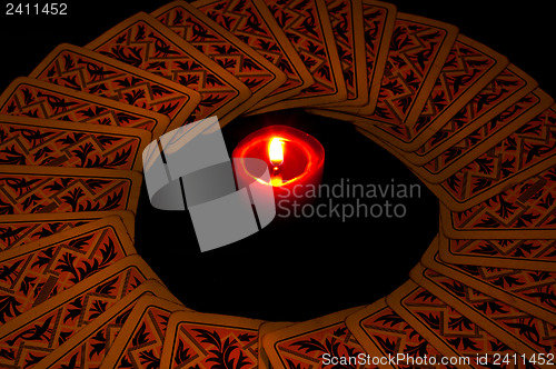 Image of circle from cards with candle