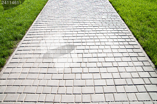 Image of sidewalk between green grass