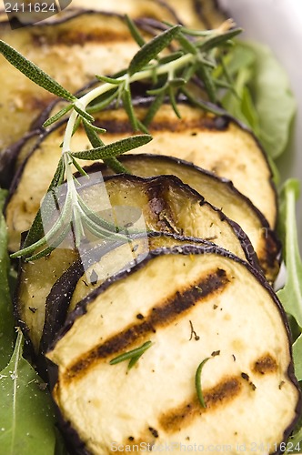 Image of Grilled eggplant slices on a plate with fresh rosemary