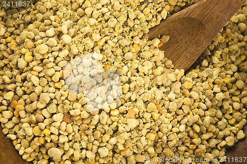 Image of Bee pollen in wooden scoop. Nutritional supplement