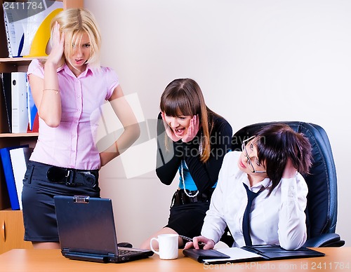 Image of Three pretty businesswomen in office