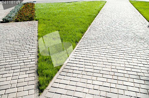 Image of sidewalk between green grass