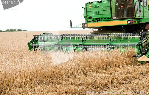 Image of combine harvester working a wheat field