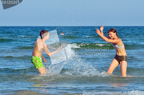 Image of children splashing at the sea