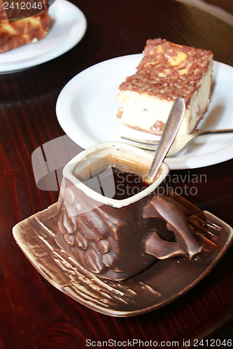 Image of cup of coffee and portion of cake