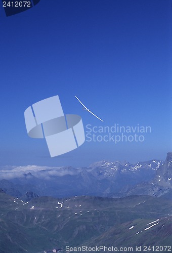 Image of Glider plane turning over Pyrenees mountain