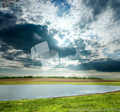 Image of view to overcast landscape with pond