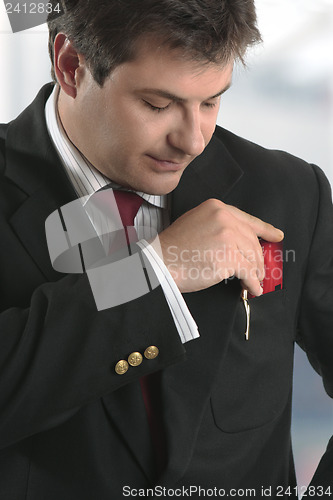 Image of Man businessman holding credit card or other plastic card