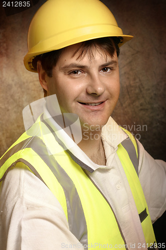 Image of Confident builder in work clothes smiling