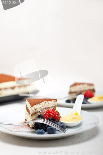 Image of tiramisu dessert with berries and cream