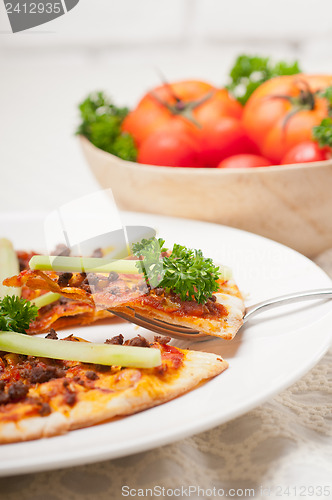 Image of Turkish beef pizza with cucumber on top