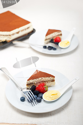 Image of tiramisu dessert with berries and cream