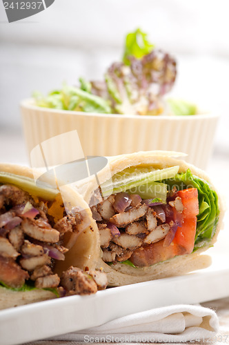 Image of kafta shawarma chicken pita wrap roll sandwich