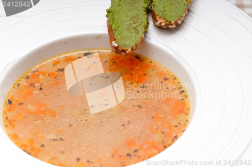 Image of Italian minestrone soup with pesto crostini on side
