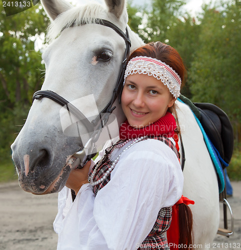 Image of Portrait of a girl next to a white horse