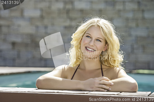 Image of Happy blond girl in pool