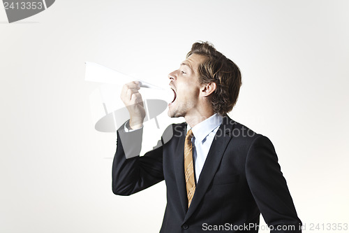 Image of Businessman eating paper airplane