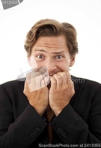 Image of Businessman chewing on his fingernails with a worried expression