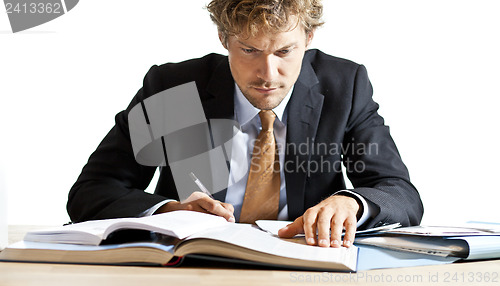 Image of Concentrated businessman working at desk