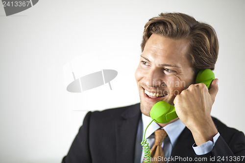 Image of Smiling businessman talking on the phone