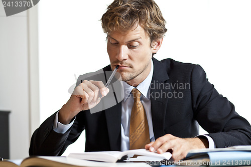 Image of Businessman trying to figure out the work