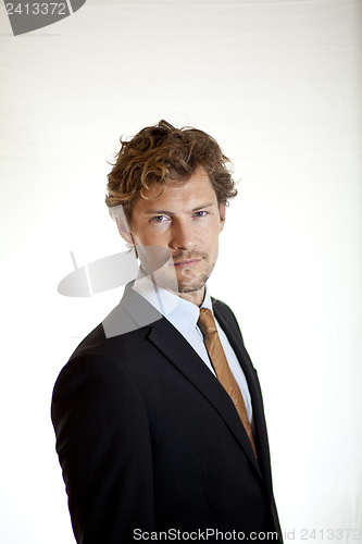 Image of Serious businessman turning to look at camera