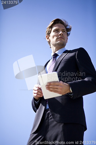 Image of Businessman holding tablet