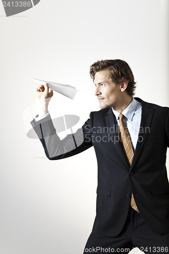 Image of Businessman throwing paper airplane